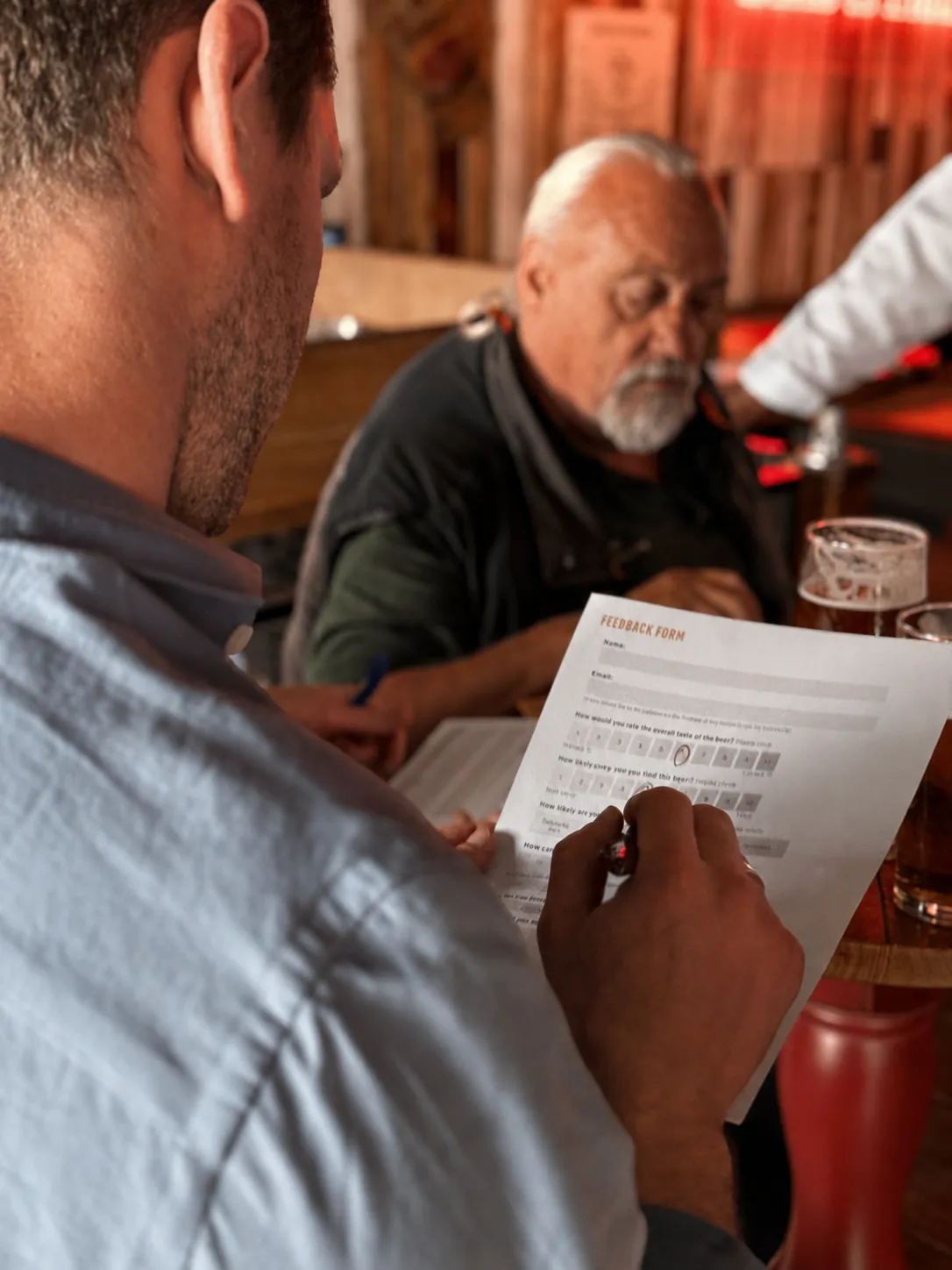 A pub-goer completing a beer feedback form during the trial