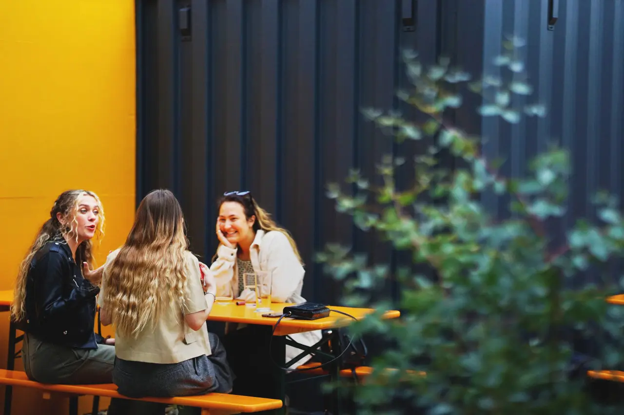 Three women chatting and drinking in Track Brewing Taproom, Manchester - creator: Matthew Curtis