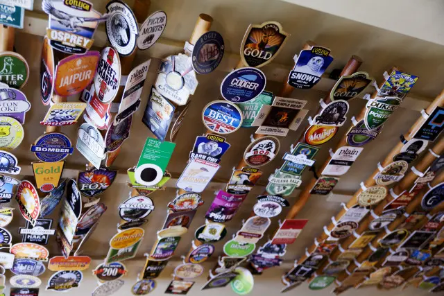 Beer logos pump badges mounted on a wall
